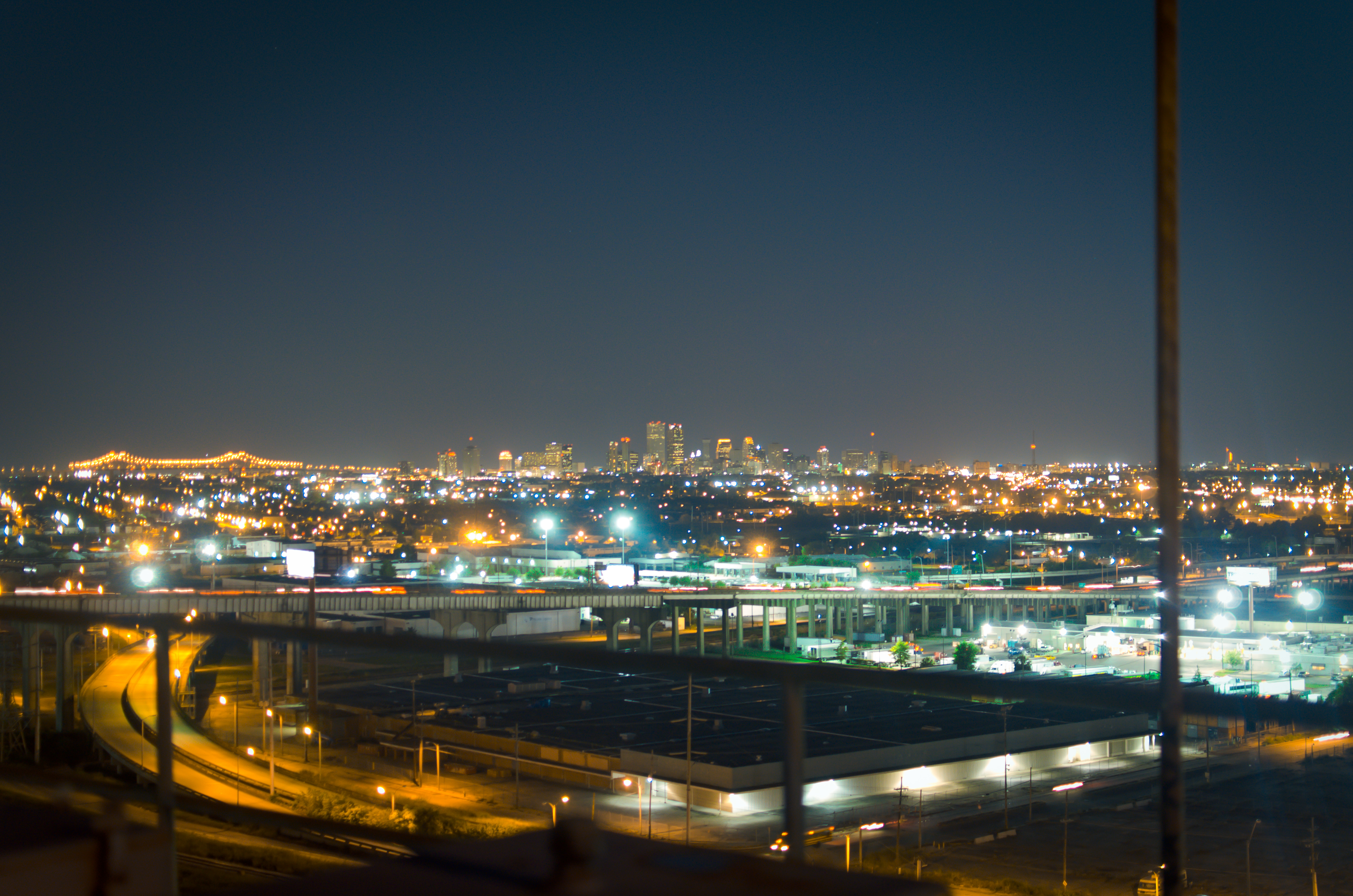 New Orleans at night, with the downtown skyline and illuminated streets viewed from Danziger Bridge
